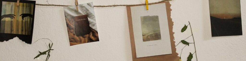 The image shows a twine clothes style line with images hanging on it via clothes pin. the hanging images are a book, a sun set, a sun rise and two hands attempting to touch .